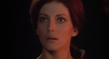 Movie still from “The Legend of Hell House” (1973), directed by John Hough – A woman's face in the dark; Close Up shot, Low angle