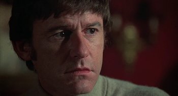Movie still from “The Legend of Hell House” (1973), directed by John Hough – A man's face as he stares into the distance; Close Up shot, Low angle