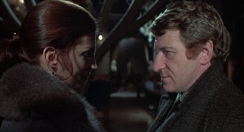 Movie still from “The Legend of Hell House” (1973), directed by John Hough – A man and a woman looking at one another; Close Up shot, Over the shoulder angle