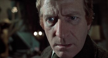 Movie still from “The Legend of Hell House” (1973), directed by John Hough – A man's face in the dark; Close Up shot, Low angle