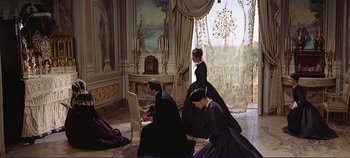 Movie still from “The Leopard” (1963), directed by Luchino Visconti – A group of people standing in a room; Wide shot, High angle