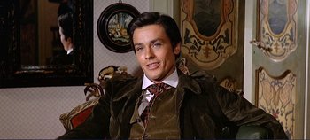 Movie still from “The Leopard” (1963), directed by Luchino Visconti – A man sitting in a chair wearing a suit and tie; Close Up shot, High angle