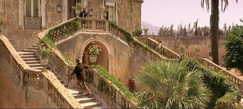 Movie still from “The Leopard” (1963), directed by Luchino Visconti – A man walking down a set of stairs; Extreme Wide shot, Low angle