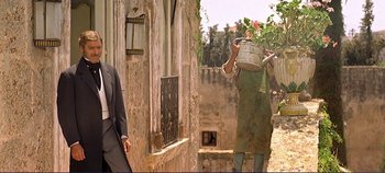 Movie still from “The Leopard” (1963), directed by Luchino Visconti – A man and a woman walking down a street; Wide shot, Low angle