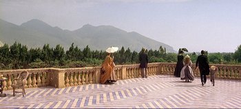 Movie still from “The Leopard” (1963), directed by Luchino Visconti – Two people are sitting on a balcony overlooking a mountain range; Extreme Wide shot, High angle