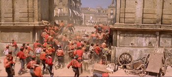 Movie still from “The Leopard” (1963), directed by Luchino Visconti – A painting of a crowd of men in red and black uniforms; Extreme Wide shot, High angle