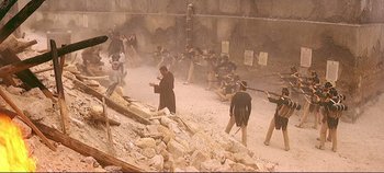 Movie still from “The Leopard” (1963), directed by Luchino Visconti – A group of men are standing in the dirt; Wide shot, High angle