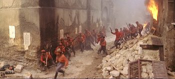 Movie still from “The Leopard” (1963), directed by Luchino Visconti – A group of men in red jackets are fighting; Wide shot, High angle