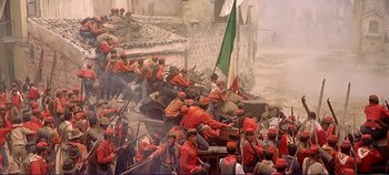 Movie still from “The Leopard” (1963), directed by Luchino Visconti – A painting of a group of men in orange and red uniforms; Extreme Wide shot, High angle