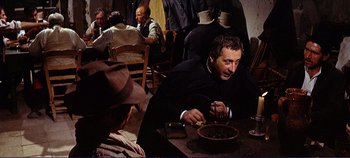 Movie still from “The Leopard” (1963), directed by Luchino Visconti – A man sitting at a table with a bowl of food in front of him; Medium shot, Over the shoulder angle