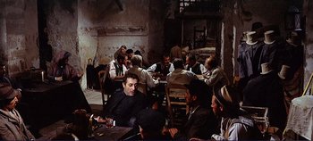 Movie still from “The Leopard” (1963), directed by Luchino Visconti – A group of men sitting around a table; Wide shot, High angle