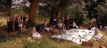 Movie still from “The Leopard” (1963), directed by Luchino Visconti – A group of people sitting under a tree; Wide shot, High angle