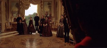 Movie still from “The Leopard” (1963), directed by Luchino Visconti – A group of people standing around in a room; Wide shot, Low angle
