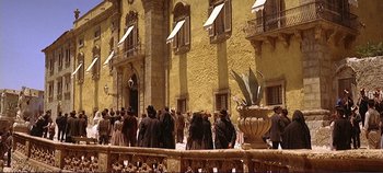 Movie still from “The Leopard” (1963), directed by Luchino Visconti – A group of people standing in front of a building; Extreme Wide shot, Low angle
