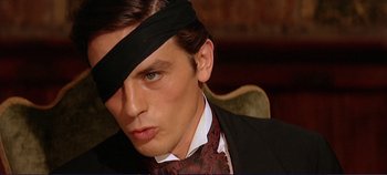 Movie still from “The Leopard” (1963), directed by Luchino Visconti – A person wearing a suit and tie; Close Up shot, Low angle