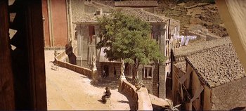 Movie still from “The Leopard” (1963), directed by Luchino Visconti – An image of an old building in the middle of the day; Extreme Wide shot, High angle