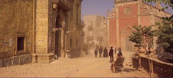 Movie still from “The Leopard” (1963), directed by Luchino Visconti – A group of people walking down a street; Extreme Wide shot, High angle