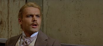 Movie still from “The Leopard” (1963), directed by Luchino Visconti – A person wearing a suit and tie; Close Up shot, Over the shoulder angle