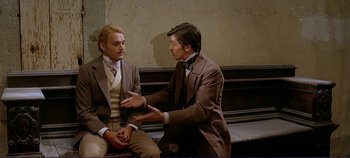 Movie still from “The Leopard” (1963), directed by Luchino Visconti – Two men sitting on top of a wooden bench; Medium shot, Over the shoulder angle