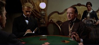 Movie still from “The Leopard” (1963), directed by Luchino Visconti – Two men sitting at a table in front of cards; Medium shot, Over the shoulder angle