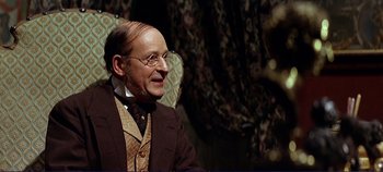 Movie still from “The Leopard” (1963), directed by Luchino Visconti – An older man wearing a suit and tie; Close Up shot, Over the shoulder angle