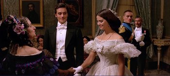 Movie still from “The Leopard” (1963), directed by Luchino Visconti – A man and a woman dressed in formal wear; Medium shot, Over the shoulder angle