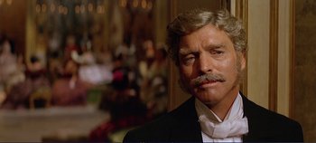 Movie still from “The Leopard” (1963), directed by Luchino Visconti – A person wearing a suit and tie; Close Up shot, Over the shoulder angle