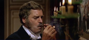 Movie still from “The Leopard” (1963), directed by Luchino Visconti – A man smoking a pipe in front of candles; Close Up shot, Low angle
