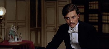 Movie still from “The Leopard” (1963), directed by Luchino Visconti – A man in a suit and a bow tie; Close Up shot, Over the shoulder angle