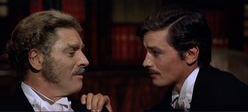 Movie still from “The Leopard” (1963), directed by Luchino Visconti – Two men in suits are facing one another; Close Up shot, Over the shoulder angle