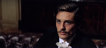 Movie still from “The Leopard” (1963), directed by Luchino Visconti – A person wearing a suit and tie; Close Up shot, Over the shoulder angle