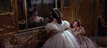 Movie still from “The Leopard” (1963), directed by Luchino Visconti – A woman in a white dress looking in the mirror; Medium shot, Over the shoulder angle