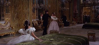Movie still from “The Leopard” (1963), directed by Luchino Visconti – A man and a woman dressed in period clothing; Wide shot, Over the shoulder angle