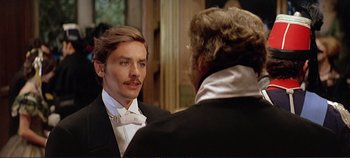 Movie still from “The Leopard” (1963), directed by Luchino Visconti – A man in a tuxedo looking at another man in a suit; Close Up shot, Over the shoulder angle