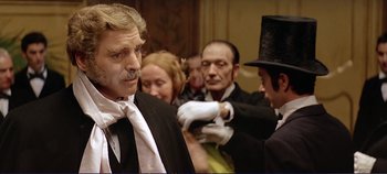 Movie still from “The Leopard” (1963), directed by Luchino Visconti – A group of people dressed up in costumes; Close Up shot, Over the shoulder angle