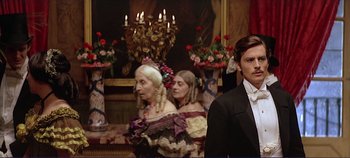 Movie still from “The Leopard” (1963), directed by Luchino Visconti – A man and a woman dressed in period clothing; Medium shot, Low angle