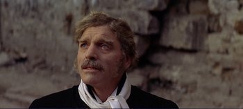 Movie still from “The Leopard” (1963), directed by Luchino Visconti – An older man with a beard and mustache wearing a neck tie; Close Up shot, Over the shoulder angle