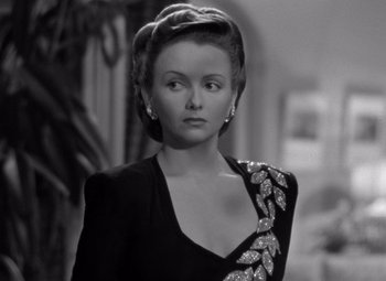 Movie still from “The Leopard Man” (1943), directed by Jacques Tourneur – An old photo of a woman in a black dress; Close Up shot, Over the shoulder angle