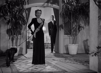 Movie still from “The Leopard Man” (1943), directed by Jacques Tourneur – A man and a woman dressed up in formal wear; Medium shot, Low angle