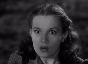 Movie still from “The Leopard Man” (1943), directed by Jacques Tourneur – A young woman with a surprised look on her face; Close Up shot, Low angle