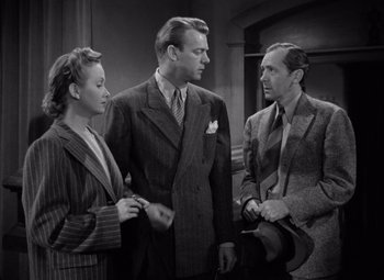 Movie still from “The Leopard Man” (1943), directed by Jacques Tourneur – A man and two women standing next to each other; Medium shot, High angle