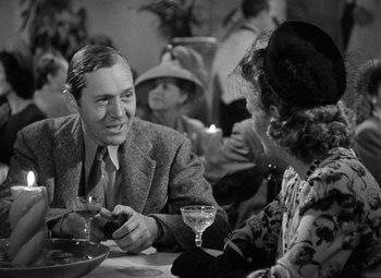 Movie still from “The Leopard Man” (1943), directed by Jacques Tourneur – An older man and woman sitting at a dinner table; Medium shot, Over the shoulder angle