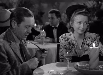 Movie still from “The Leopard Man” (1943), directed by Jacques Tourneur – A man and a woman sitting at a dinner table; Close Up shot, Over the shoulder angle
