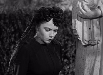 Movie still from “The Leopard Man” (1943), directed by Jacques Tourneur – A black and white photo of a woman with a veil; Medium shot, Low angle