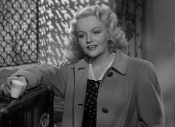 Movie still from “The Leopard Man” (1943), directed by Jacques Tourneur – An old black and white photo of a woman with blonde hair; Medium shot, High angle