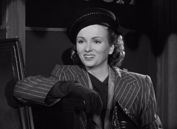 Movie still from “The Leopard Man” (1943), directed by Jacques Tourneur – A black and white photo of a woman wearing a hat; Medium shot, Low angle