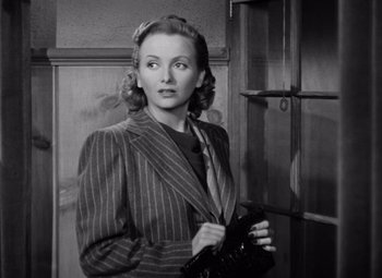 Movie still from “The Leopard Man” (1943), directed by Jacques Tourneur – An old photo of a woman holding a camera; Close Up shot, High angle