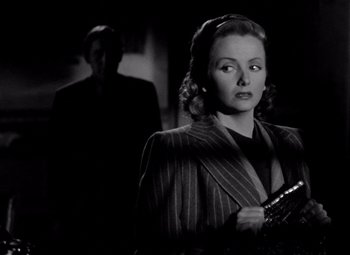 Movie still from “The Leopard Man” (1943), directed by Jacques Tourneur – A man and a woman standing in front of each other; Medium shot, Over the shoulder angle