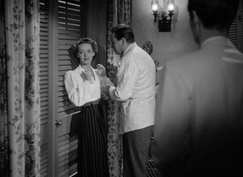Movie still from “The Letter” (1940), directed by William Wyler – A man and a woman in front of a mirror; Medium shot, Over the shoulder angle