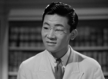 Movie still from “The Letter” (1940), directed by William Wyler – An old photo of a man wearing a suit and tie; Close Up shot, High angle